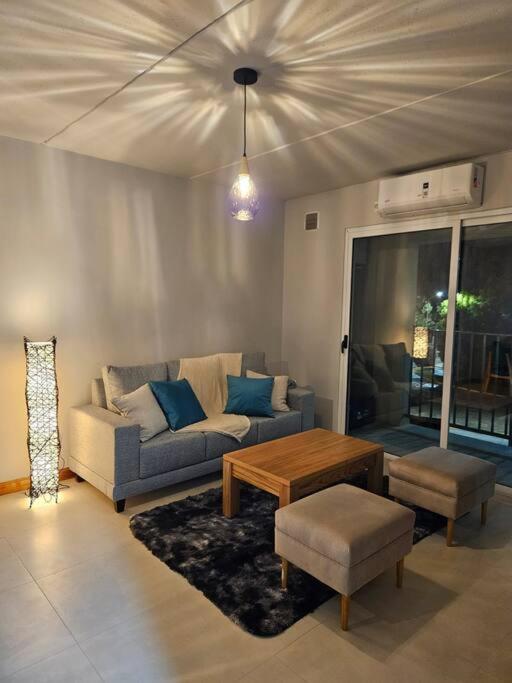 a living room with a couch and a table at Portal de Tupungato in Tupungato