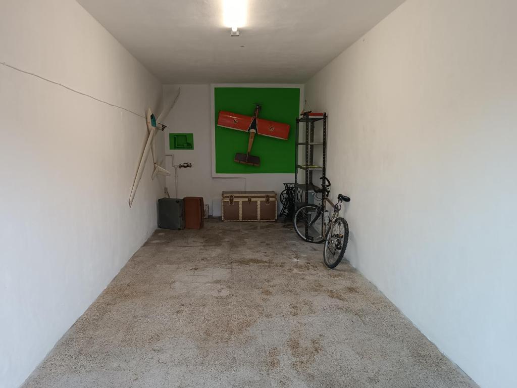 a bike parked in a room with a green wall at La Vista Storica in Piombino