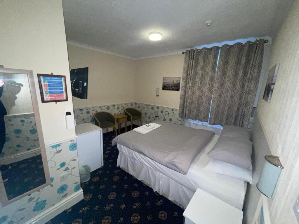 a hotel room with a bed and a mirror at THE WILFORD HOTEL in Blackpool