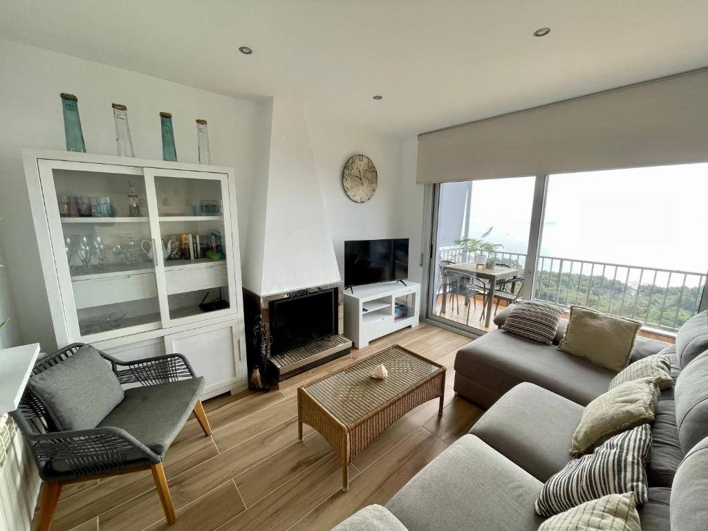 a living room with a couch and a tv at SeaHomes Vacations, LA CASA BLUE Mediterranean Lifestyle in Blanes