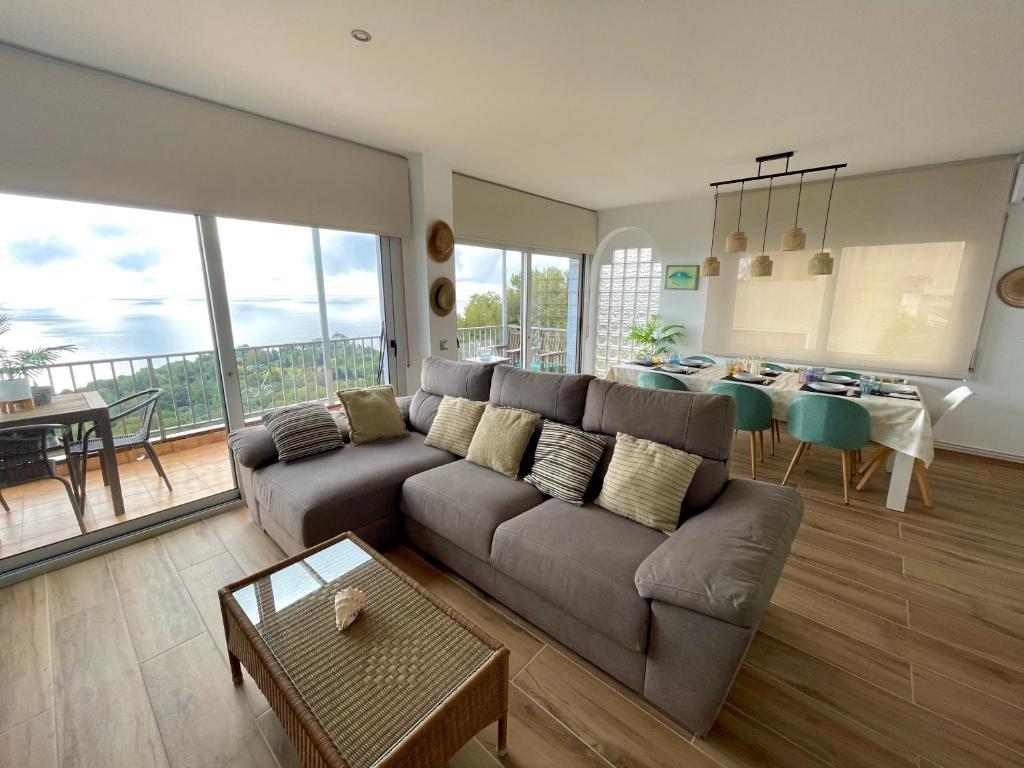 a living room with a couch and a table at SeaHomes Vacations, LA CASA BLUE Mediterranean Lifestyle in Blanes