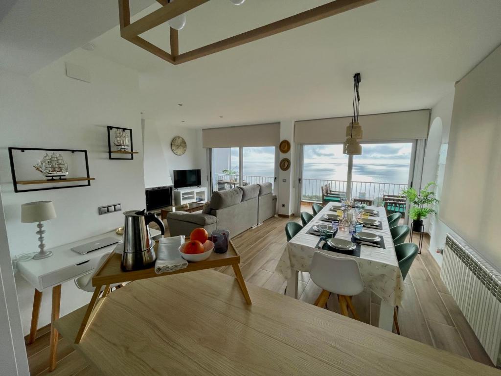 a living room with a table and a couch at SeaHomes Vacations, LA CASA BLUE Mediterranean Lifestyle in Blanes