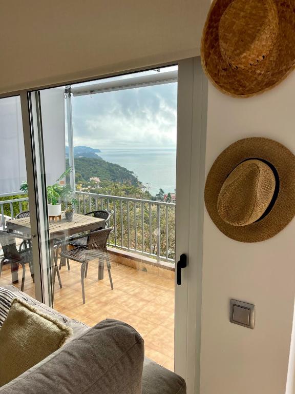 a living room with a view of the ocean at SeaHomes Vacations, LA CASA BLUE Mediterranean Lifestyle in Blanes