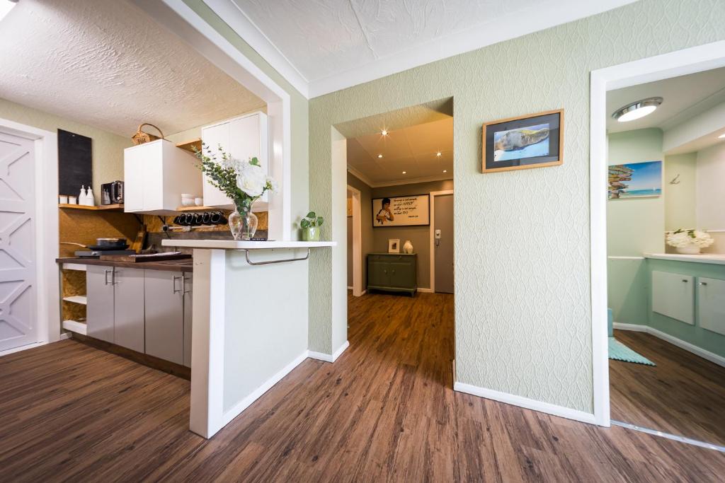 an open kitchen and living room with a white door at City Style Lofts in Sheffield