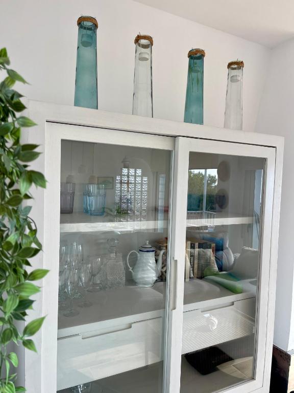 a white cabinet with blue vases on top of it at SeaHomes Vacations, LA CASA BLUE Mediterranean Lifestyle in Blanes