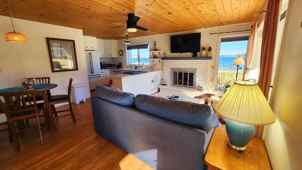 a living room with a couch and a table at Watercolors Retreat on Crooked Lake in Conway