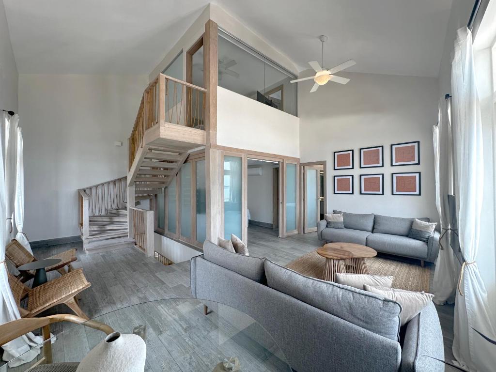 a living room with a couch and a staircase at AmazINN Places Casa del Mar in Panama City