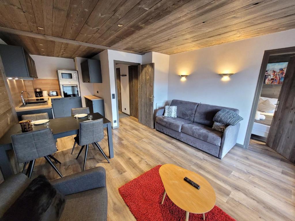 a living room with a couch and a table at Charmant T2 près pistes, Les Gets, balcon, parking, wifi - FR-1-598-135 in Les Gets