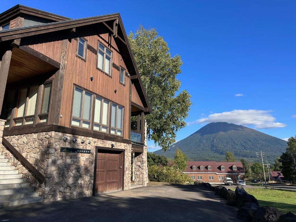 a wooden house with a mountain in the background at Annabelle - Vacation STAY 28455v in Niseko