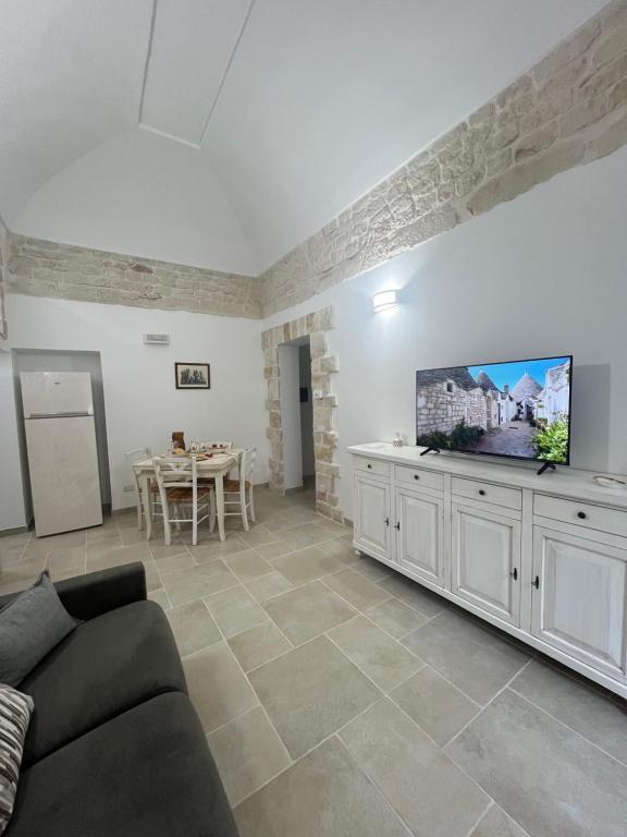 a living room with a couch and a flat screen tv at Home Civico 44 in Ceglie Messapica