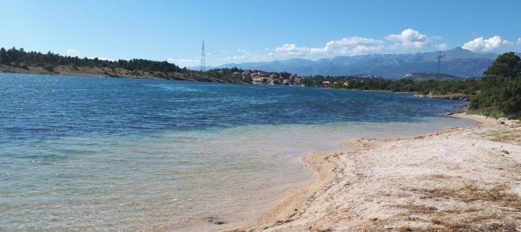 ein Wasserkörper mit Bäumen und Bergen im Hintergrund in der Unterkunft Apartments Viki in Kruševo