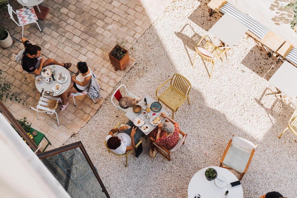 an overhead view of a group of people sitting at a table at Ses Sucreres Small & Slow Hotel in Ferreries