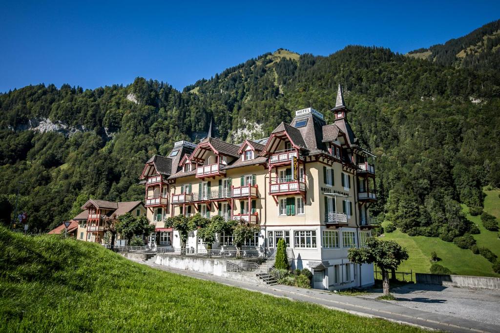 a large house on the side of a hill at Hotel Alpenhof in Kerns