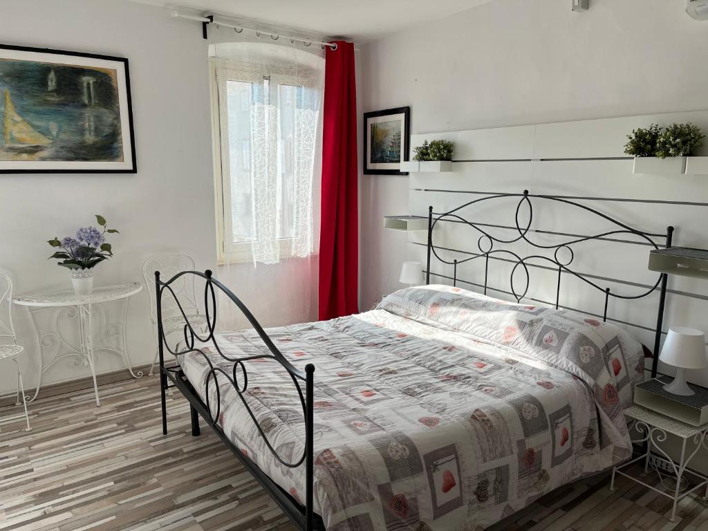 a bedroom with a bed and a red curtain at Erikasa Riva della Torre Cormons in Cormòns