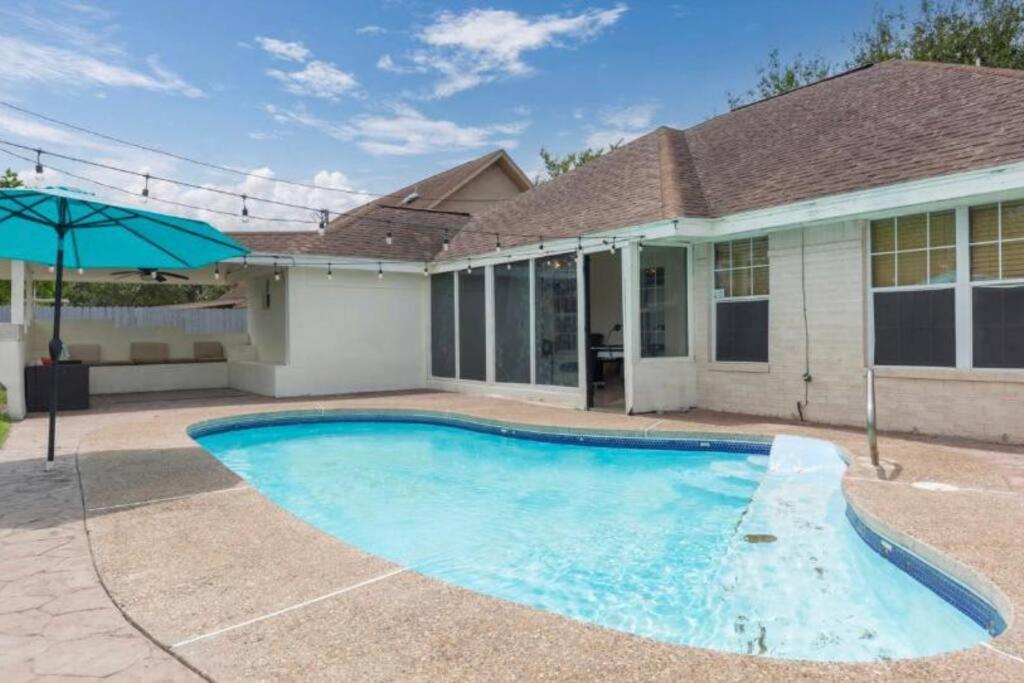 a swimming pool in front of a house at McAllen 4BR with Pool, Shopping & More in McAllen