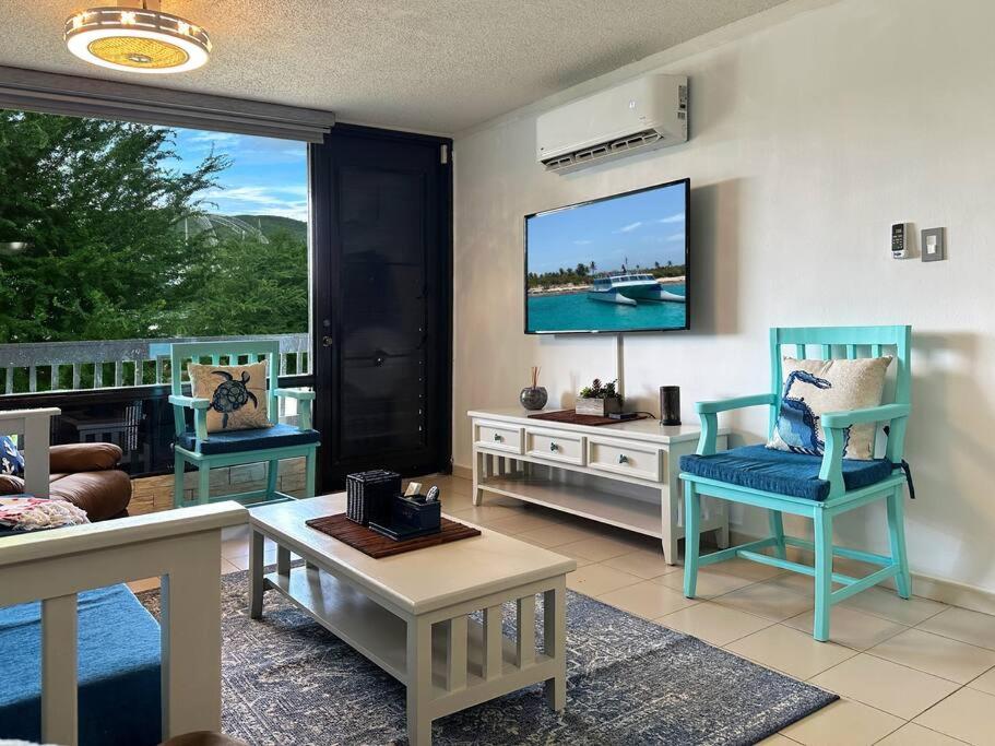 a living room with two chairs and a tv at Marina View Condo 2 Bed / 2 Bath Sleeps 7 in Fajardo