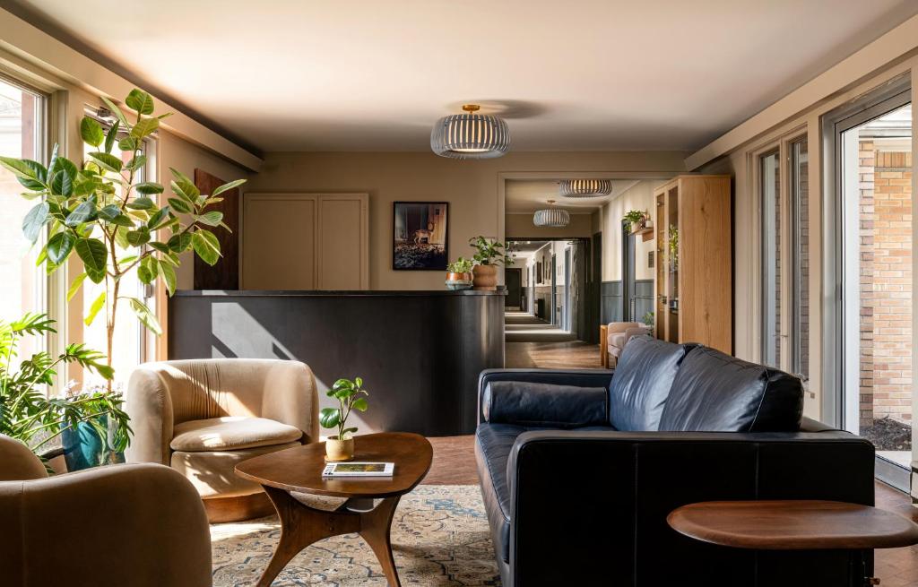 a living room with a couch and chairs at The Darby in Beach Lake