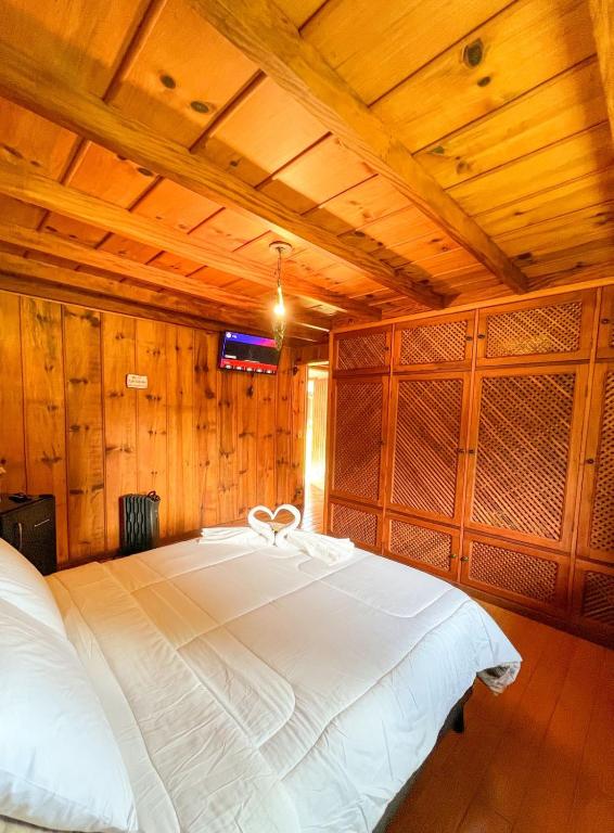 Posteľ alebo postele v izbe v ubytovaní Chalé Bolzano Monte Verde MG