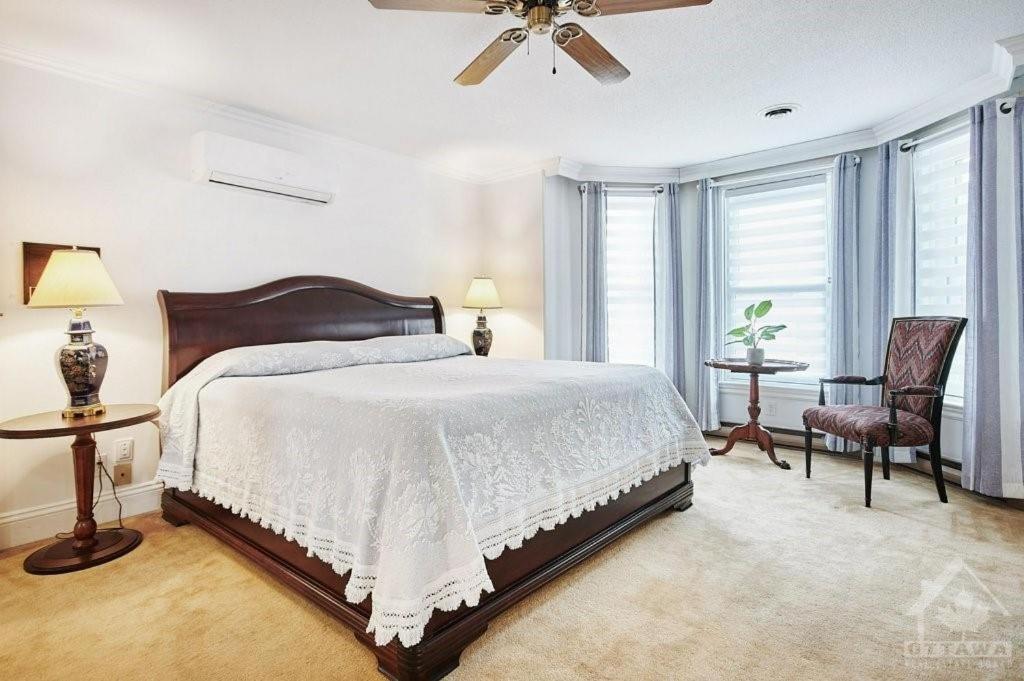 a bedroom with a bed and a ceiling fan at Inn By The Park Morrisburg in Morrisburg