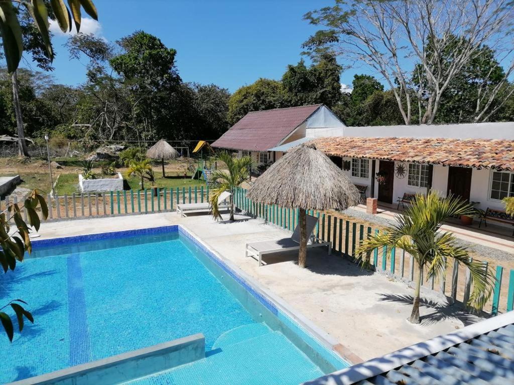 a swimming pool in front of a house at Casa Pueblo Ocú in El Hatillo