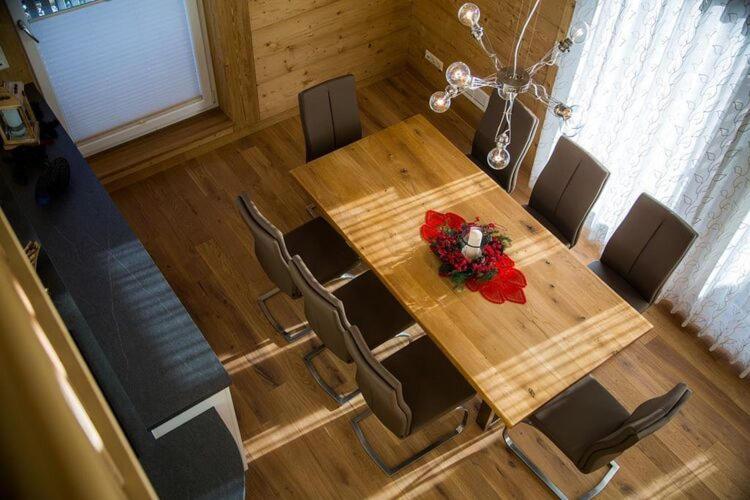 a dining room table with chairs and a vase of flowers at Nice apartment in Bolsterlang in Bolsterlang