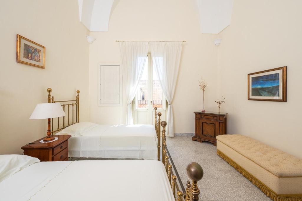 Łóżko lub łóżka w pokoju w obiekcie Palazzo Rizzo