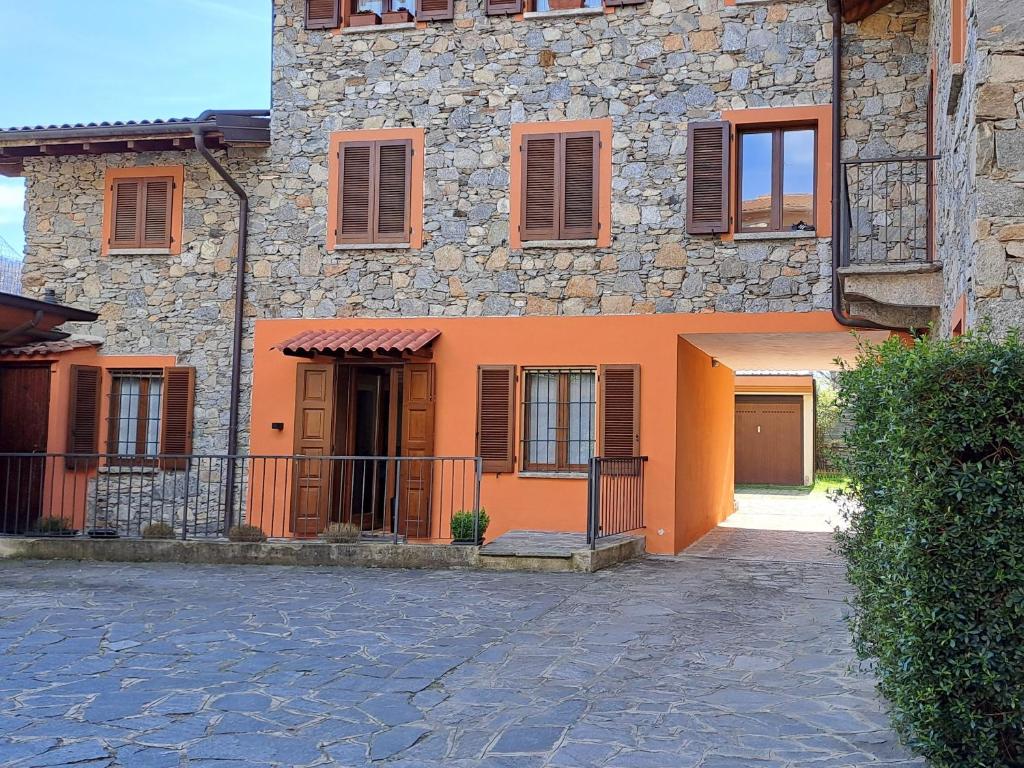 an orange building with a fence in front of it at Mila Apart in Ghevio