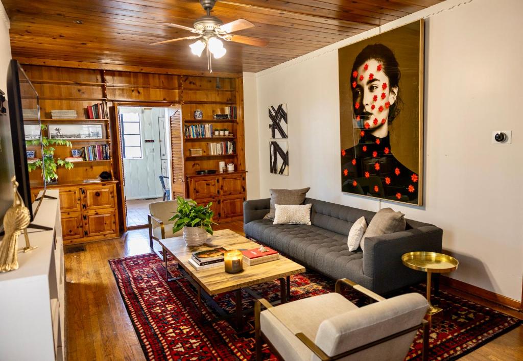 a living room with a couch and a painting at Room for Everyone! 6-Bedroom/4 Bath Austin Getaway in Austin