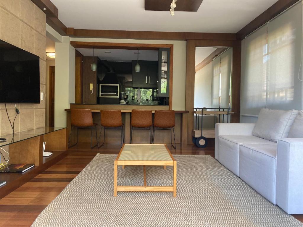 a living room with a white couch and a table at Apartamento Quinta da Serra - Canela in Canela