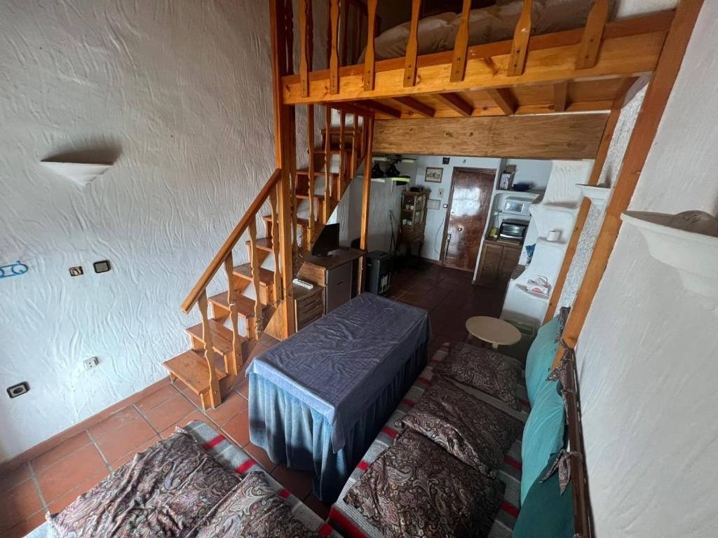 a room with a staircase and a bed in it at ALCAZABA CON VISTAS INCREIBLES in Sierra Nevada