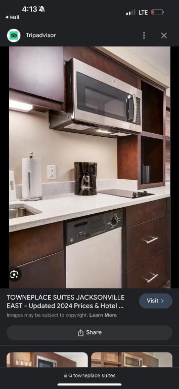 a kitchen with a microwave oven and a stove at TownePlace Suites Jacksonville Airport in Jacksonville