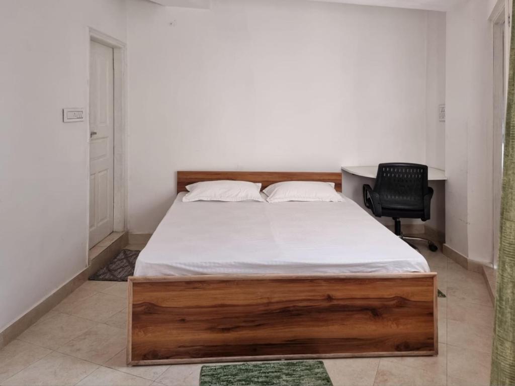 a bedroom with a bed and a desk and a chair at TiNY HOMESTAY for International Guest only in Shimla