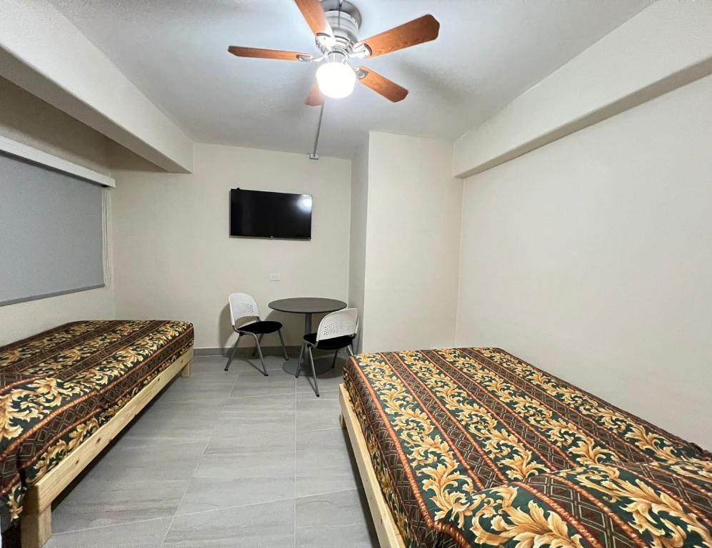 Postel nebo postele na pokoji v ubytování HOTEL VILLAGRAN
