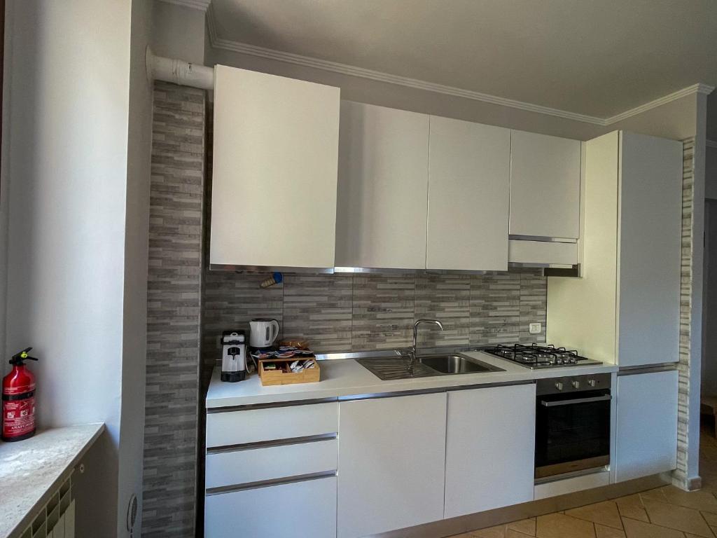 a kitchen with white cabinets and a sink at RESIDENCE VIOLA in Foggia