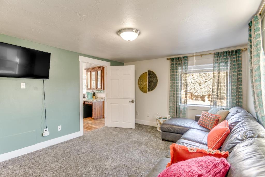 a living room with a couch and a television at Cozy and Pet-Friendly Rexburg Home with Fenced Yard! in Rexburg