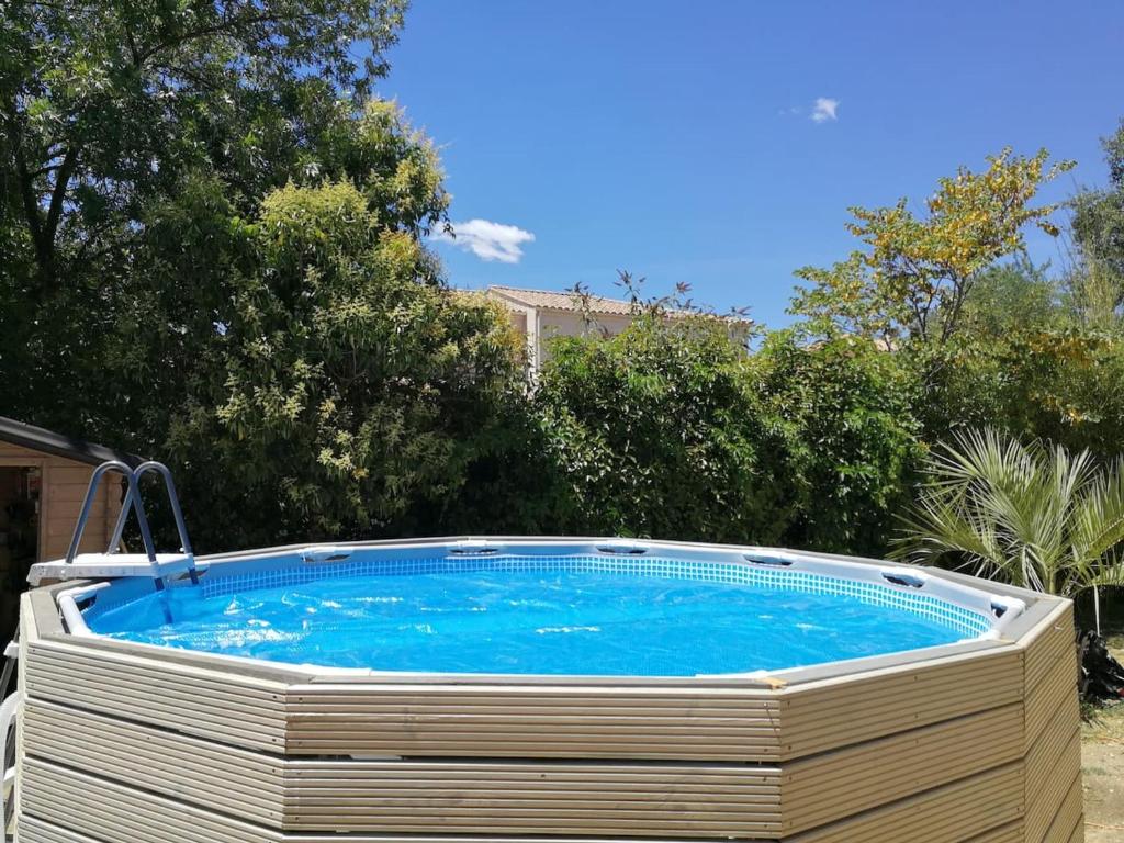 a large swimming pool in a yard with trees at Maison de 3 chambres avec piscine privee jardin clos et wifi a Saint Gely du Fesc in Saint-Gély-du-Fesc