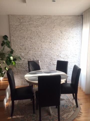 a dining room with a table and four chairs at D&E Apartments in Vienna
