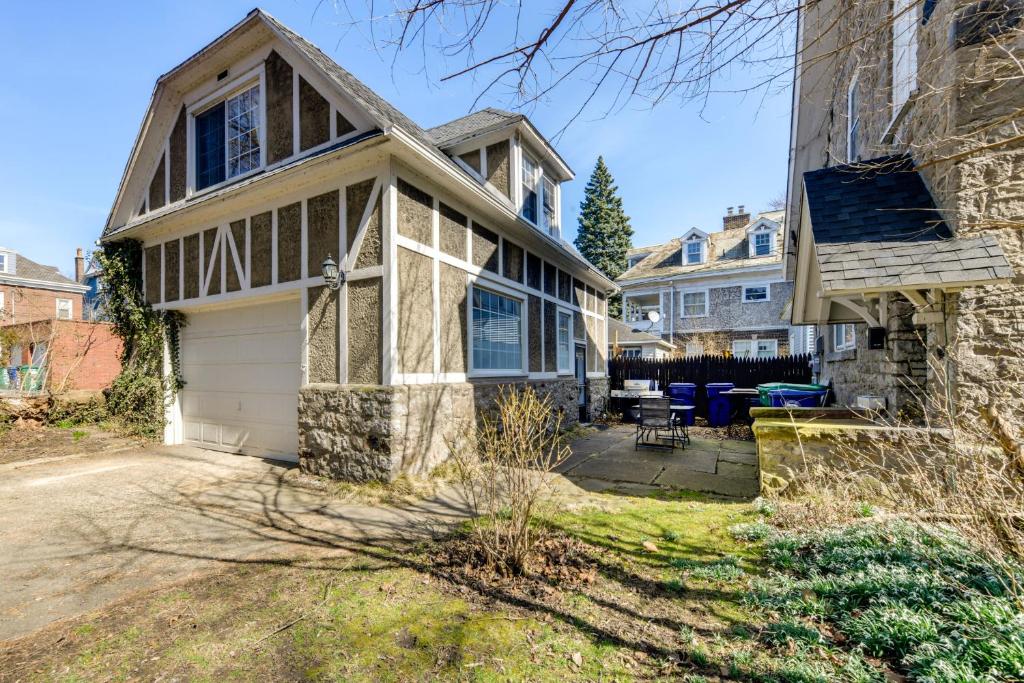 a house with a garage and a patio at Cozy Niagara Falls Cottage with Gas Grill and Patio! in Niagara Falls