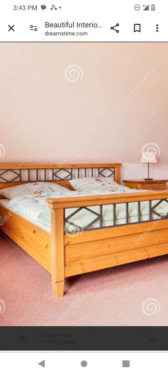 a picture of a wooden bed in a room at The alatica grand oak in Austin