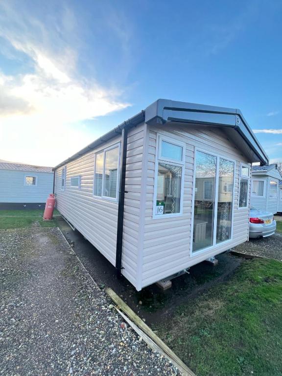 a tiny house is parked in a yard at F14 in Sandown