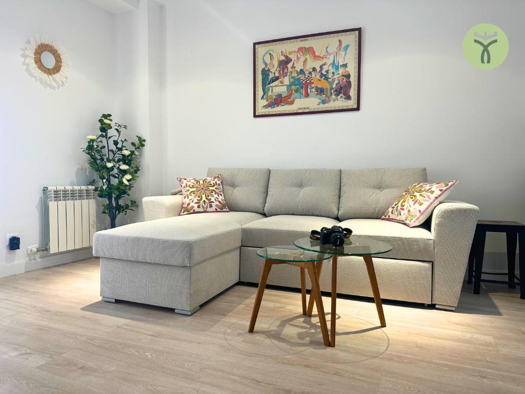 a living room with a couch and a table at Dos Torres Tranvía in Zaragoza
