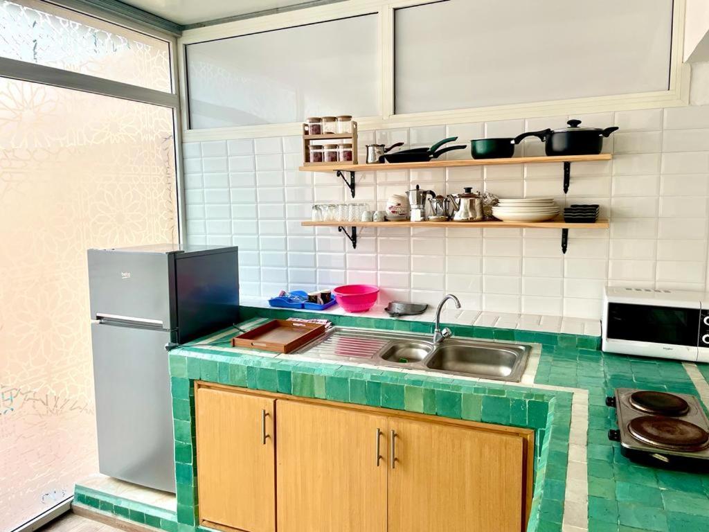 a kitchen with a sink and a refrigerator at New Luxurious apartment Agdal Rabat center in Rabat