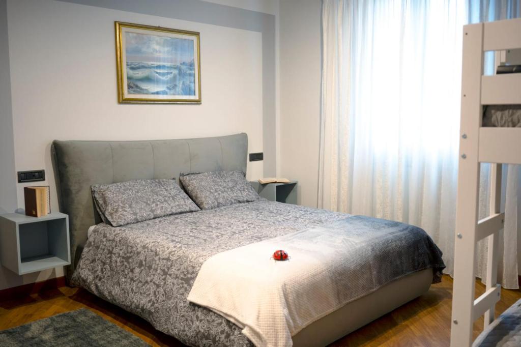a bedroom with a bed with a red flower on it at HOLIDAY HOUSE LE COCCINELLE in Salò