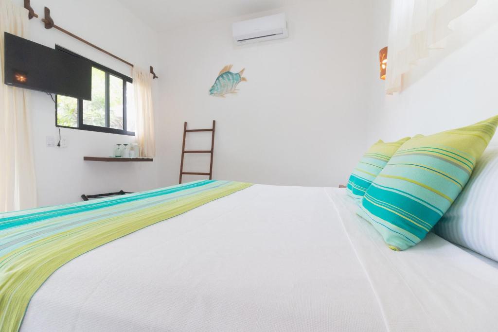 Postel nebo postele na pokoji v ubytování Maison Bacalar