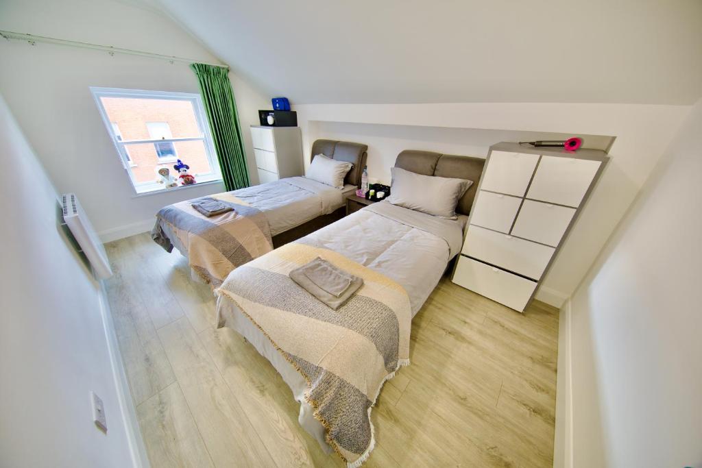 a bedroom with two beds and a window at Mary St House 3B in Dublin