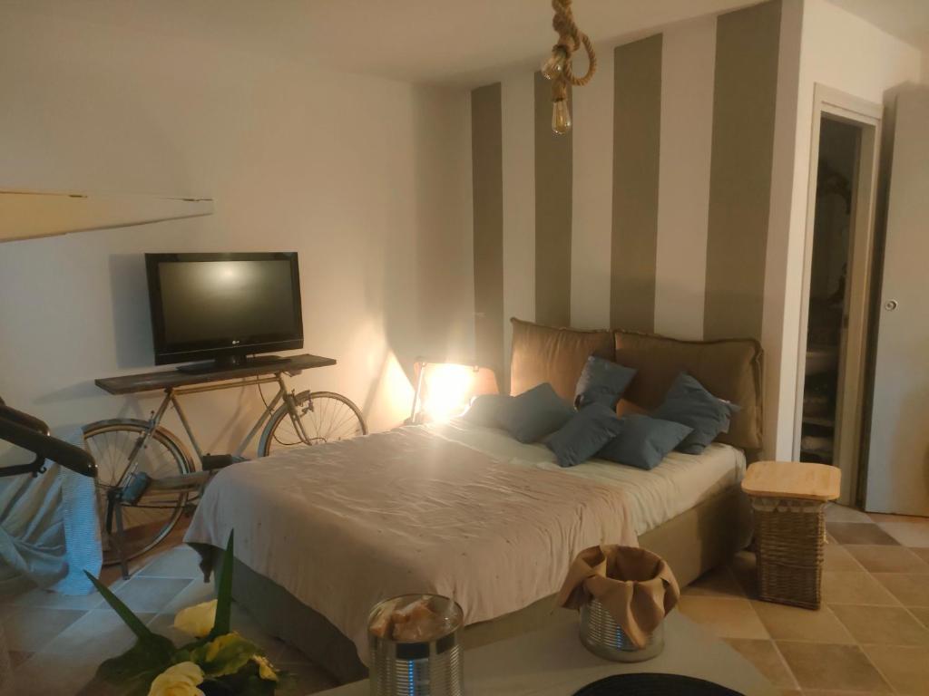 a bedroom with a bed with a television and a table at La casa di Noah in Montecatini Terme