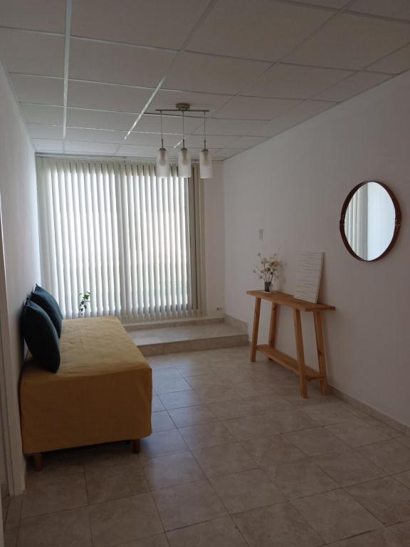 a room with a bed and a mirror and a table at Lodge de Aranda 1 in Maipú