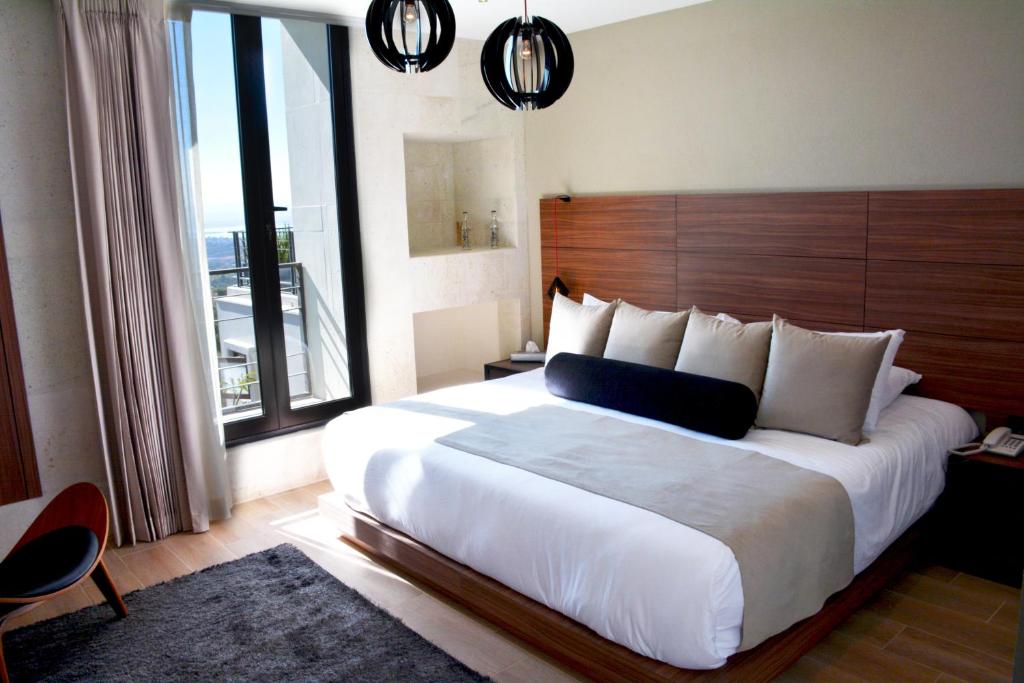 Postel nebo postele na pokoji v ubytování Ilo Rojo Hotel Boutique