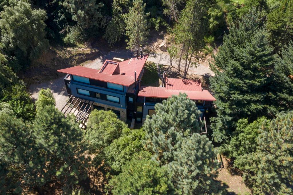 an aerial view of a house with a red roof at SIETEFLORES Lodge Casas in San Martín de los Andes