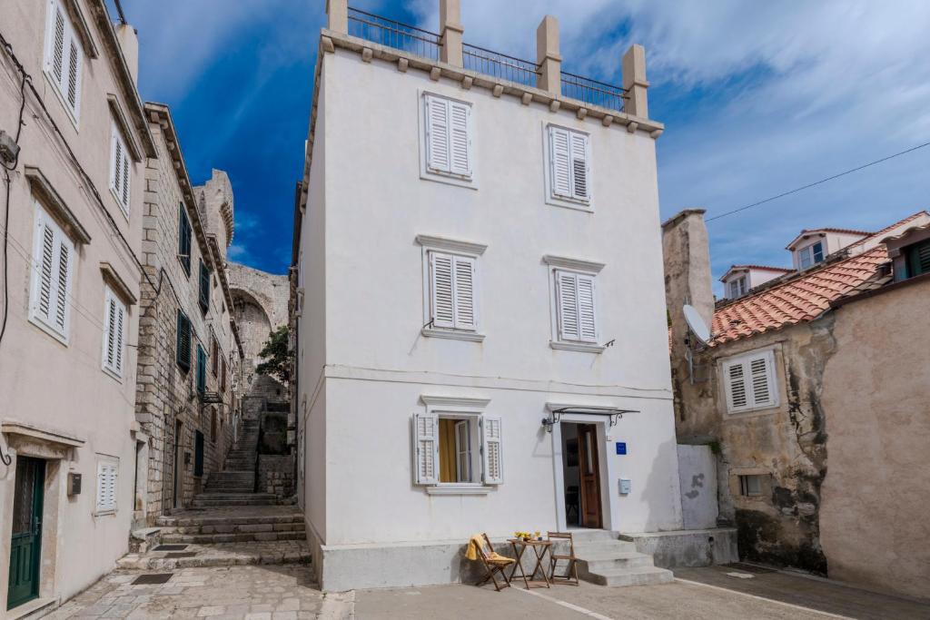 a large white building in an alley way at Welcome Apartment - Old Town in Dubrovnik